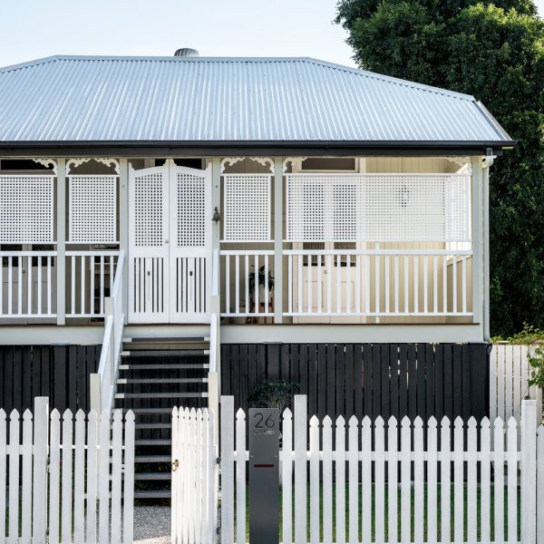 Image of a charming white house featuring a well-crafted timber stair stringer