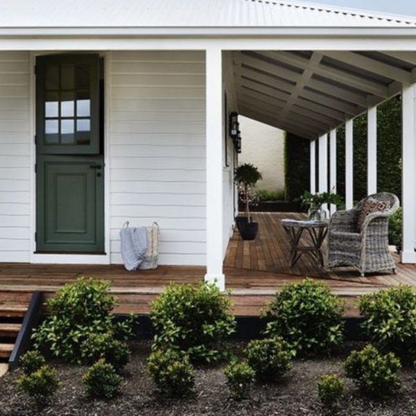 A charming house exterior highlights a 3-step stringer kit, enhanced by flourishing plants for a refreshing natural vibe.